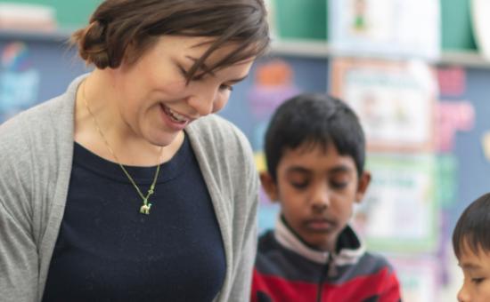 Teacher Reading To Elementary School Students